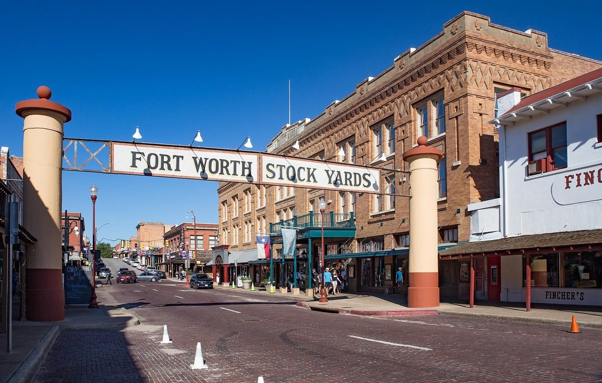 The entrance gateway to the Fort Worth Stockyards, over a brick street lined with historic buildings